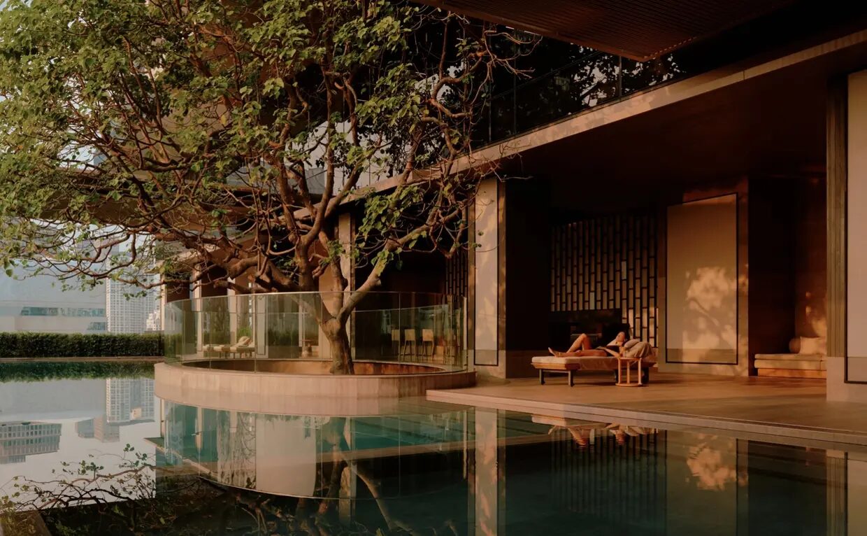 The wellness pool at Aman Nai Lert Bangkok, set among the trees of Nai Lert Park at dusk