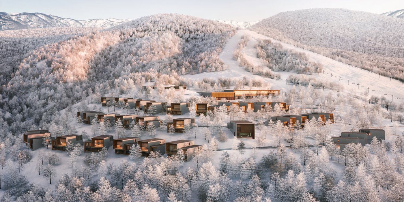 Aman Niseko seen from above in winter: low timber and stone villas scattered through frosted birch forest on the slopes of Mount Moiwa, with a ski piste and lift line running up the mountain behind, courtesy of Aman