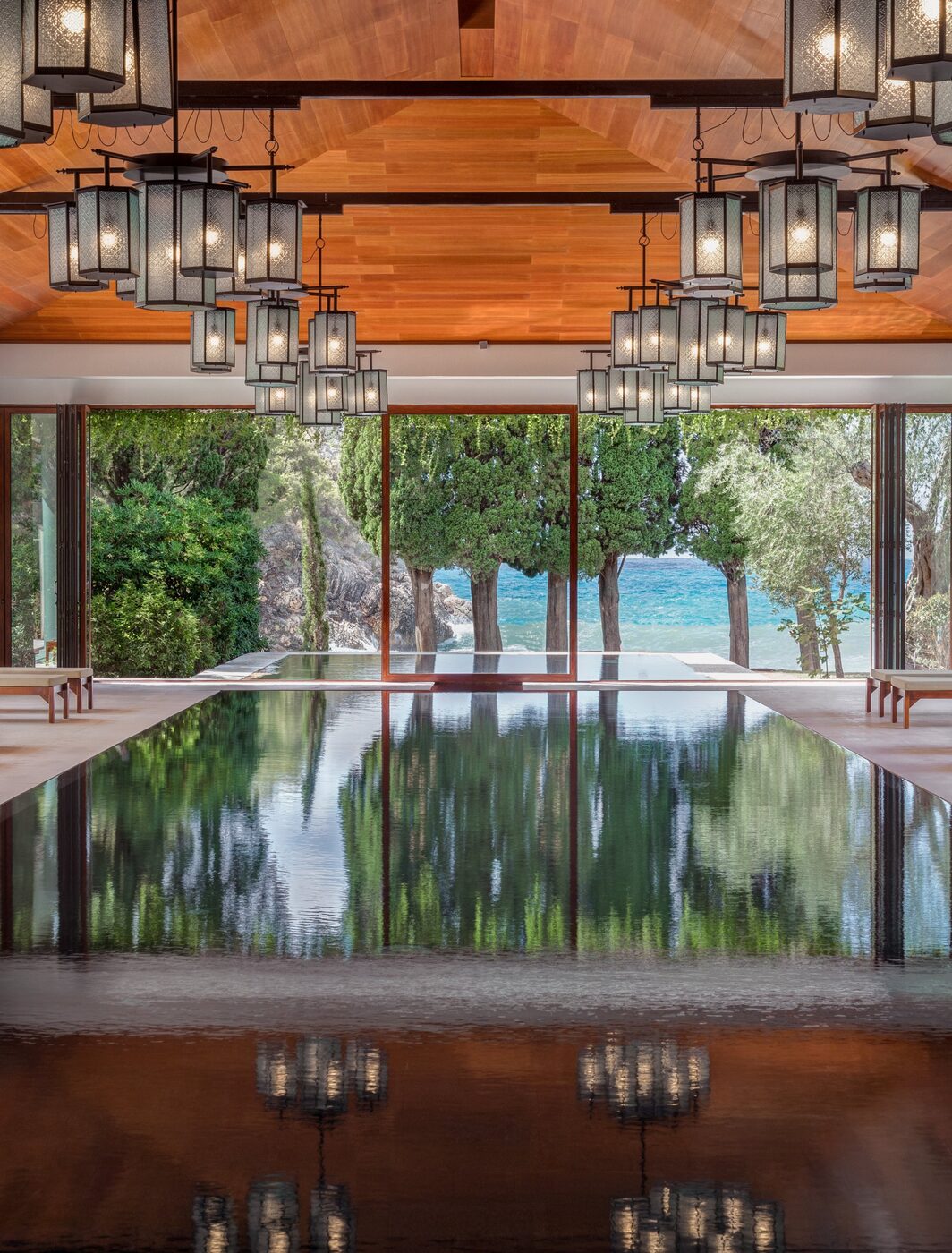 The Aman Spa indoor pool at Aman Sveti Stefan, framed by arched openings to the sea.