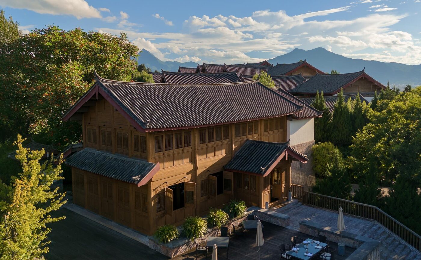 Man Yi Xuan, Amandayan's Chinese restaurant, lit at dusk beneath the mountains above Lijiang, courtesy of Aman