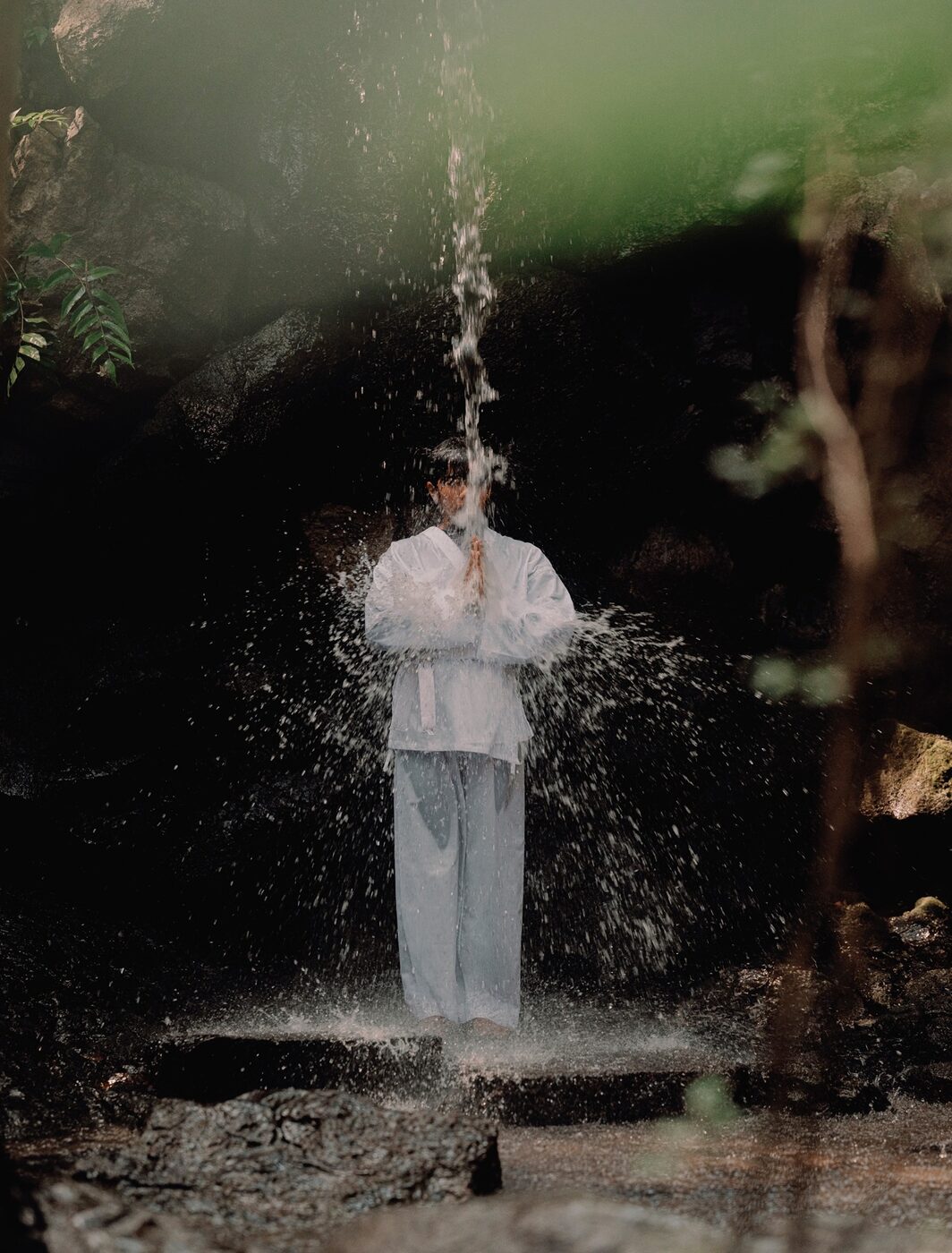Water falling over a stone lantern during a purification ritual near Amanemu, Ise-Shima