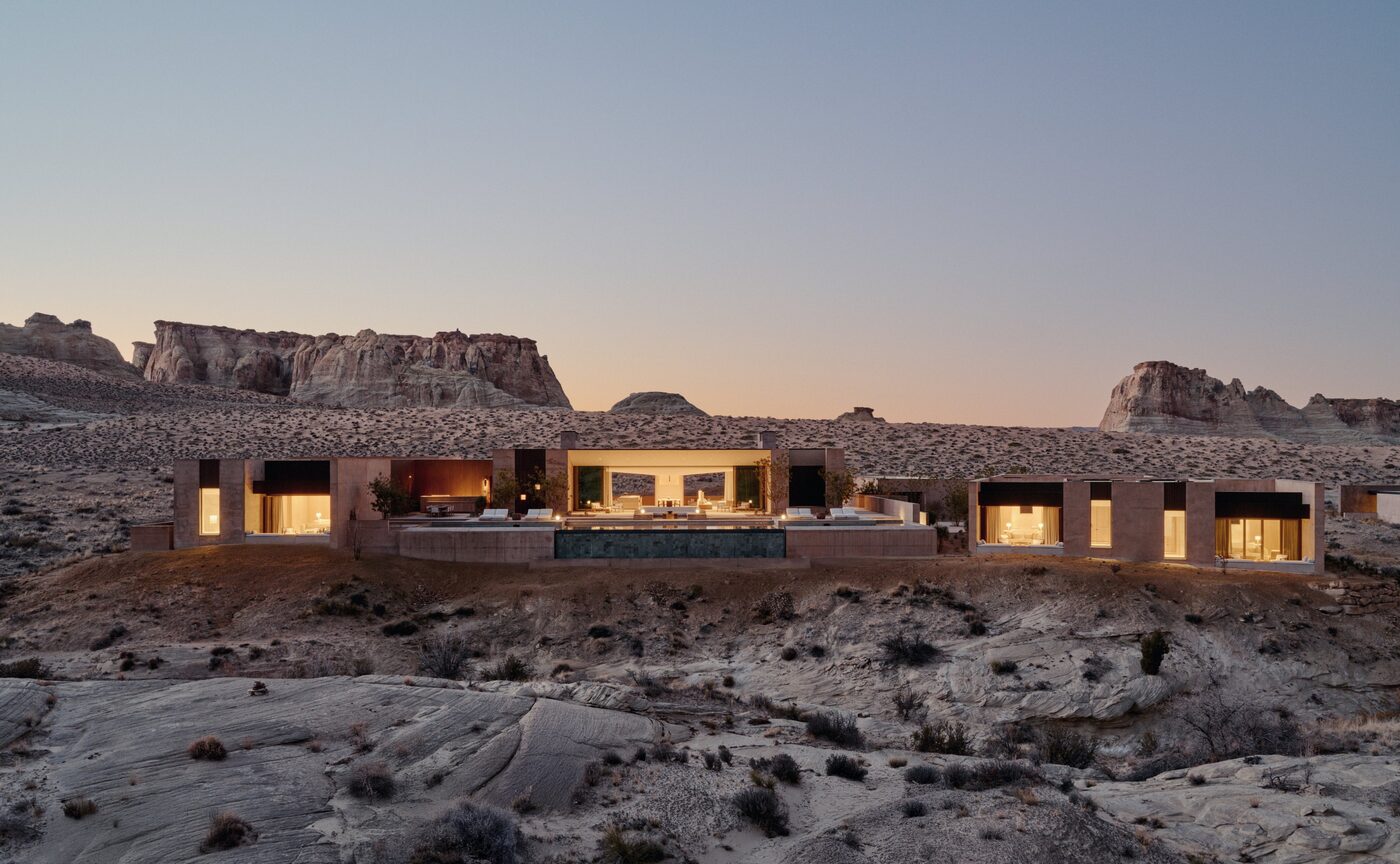 The Six-Bedroom Ridge Villa at Amangiri lit at dusk, low concrete volumes against the Utah desert, courtesy of Aman