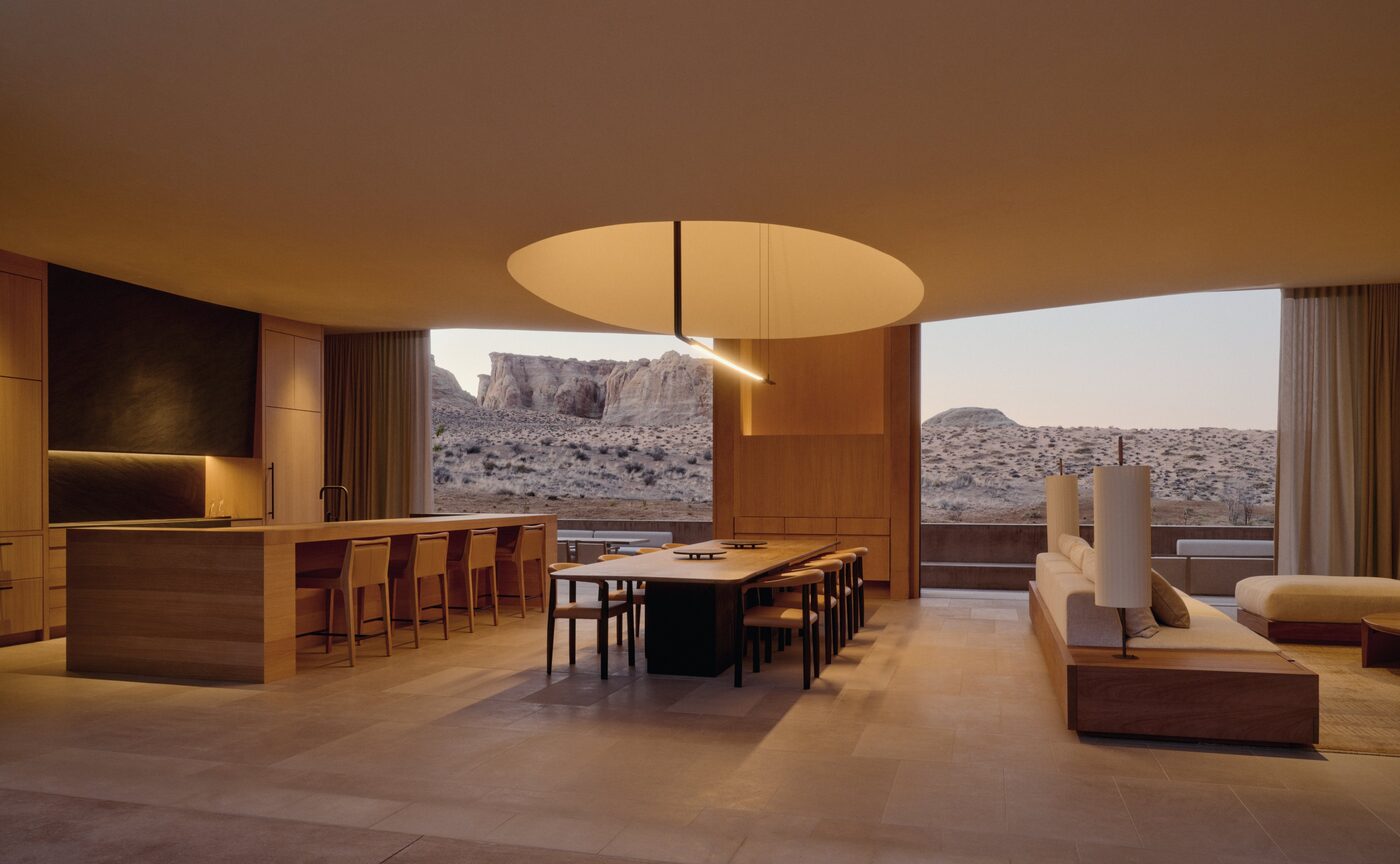 Open-plan living and dining room of the Six-Bedroom Ridge Villa at Amangiri, warm timber furniture and desert views, courtesy of Aman
