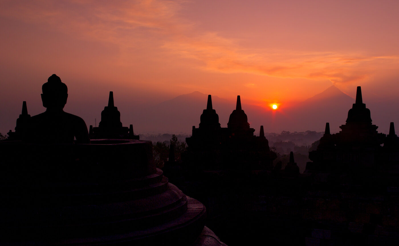 Borobudur temple silhouetted against the dawn sky above the Kedu Plain in Central Java
