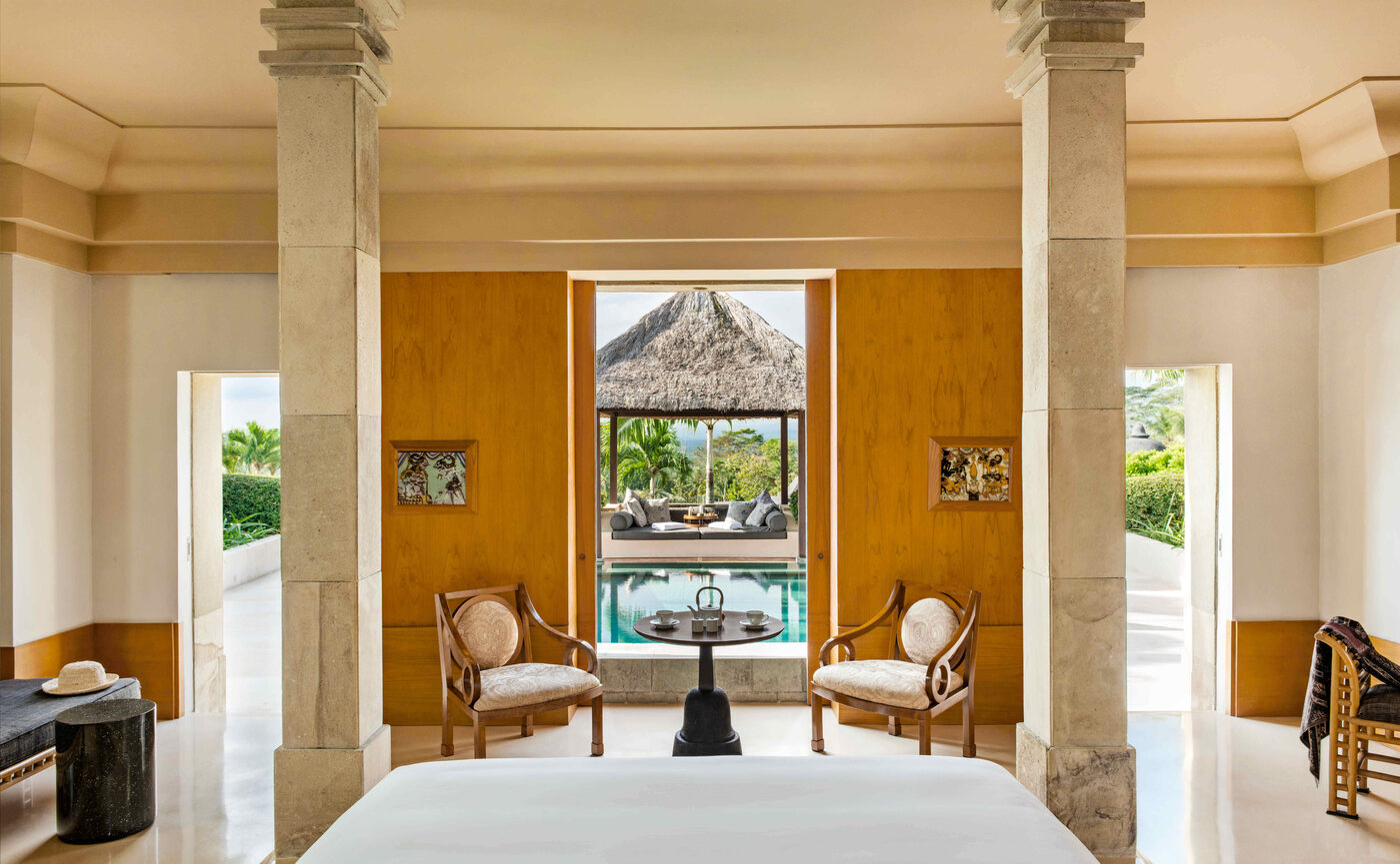 A garden pavilion at Amanjiwo with ochre walls, stone columns and a terrace opening onto tropical grounds