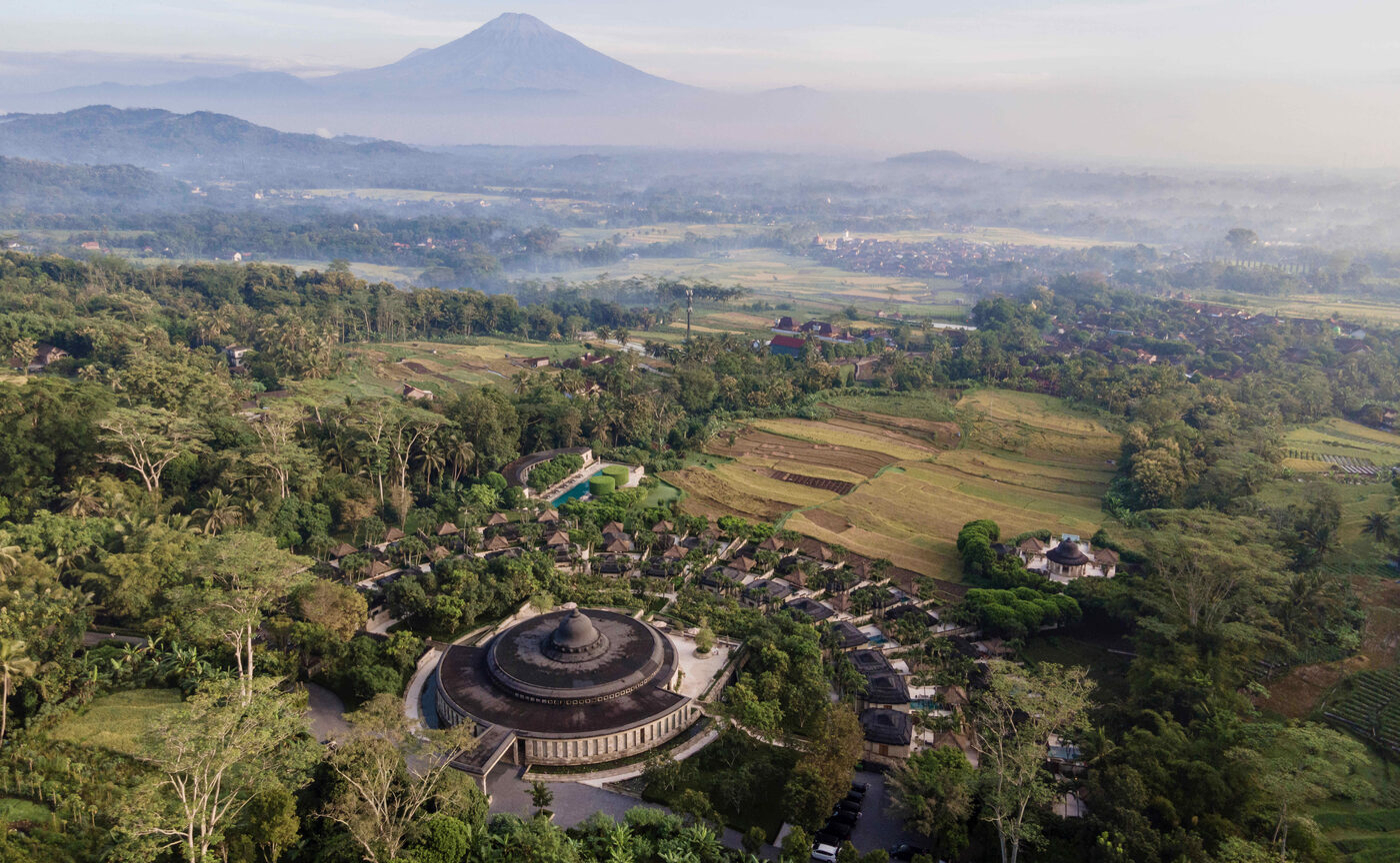 Aerial view of Amanjiwo's limestone rotunda and crescents of pavilions set among rice terraces in Central Java