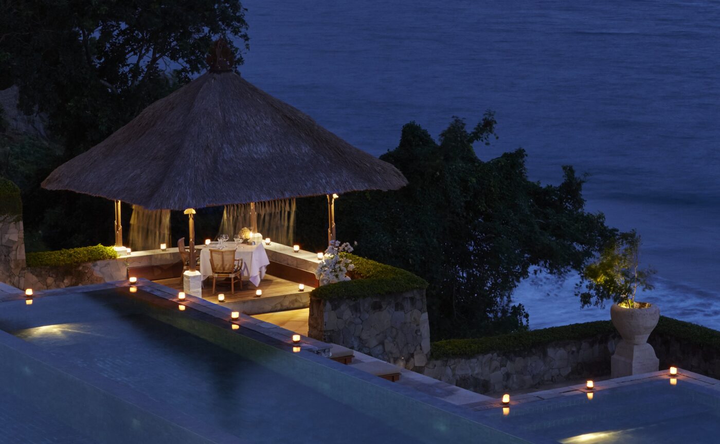 Bhoga Samatra, Amankila's new poolside Balinese dinner, lit at dusk above the Lombok Strait, courtesy of Aman