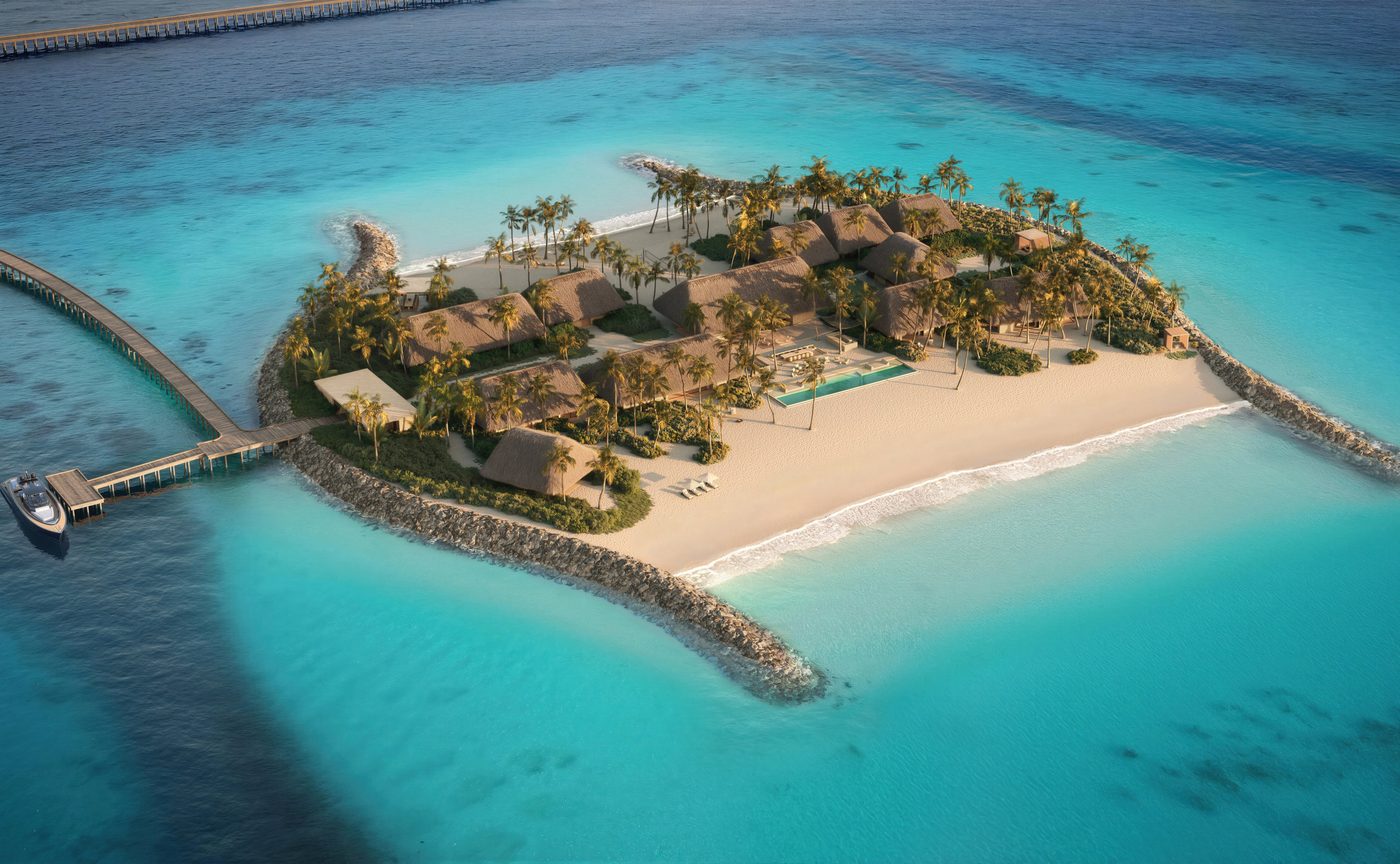 Aerial rendering of a double beach island residence at Amanolu, thatched pavilions and a lap pool on a small island with sand on both sides and a jetty, courtesy of Aman