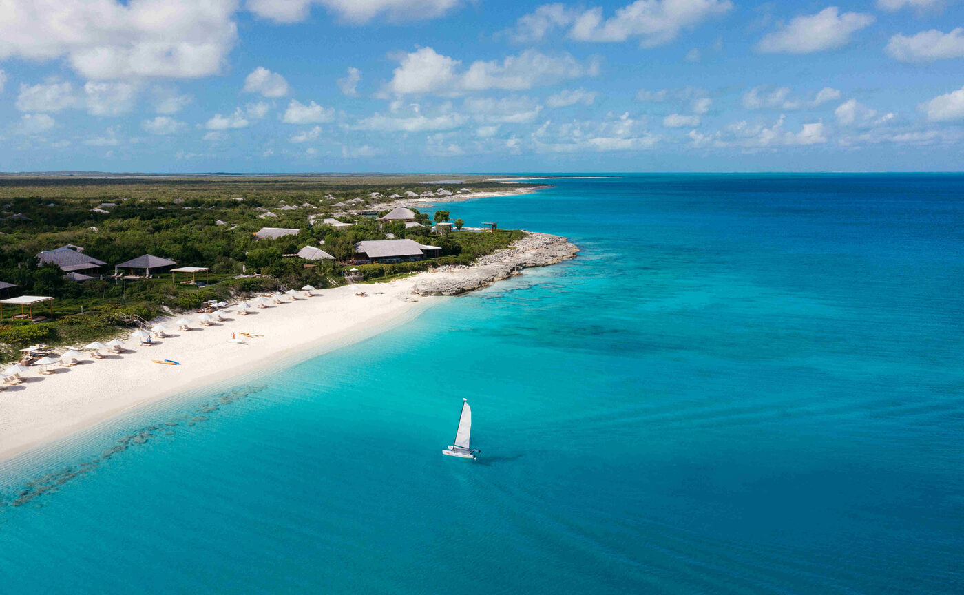 A sailboat off the white sand shoreline at Amanyara, Providenciales, Turks and Caicos
