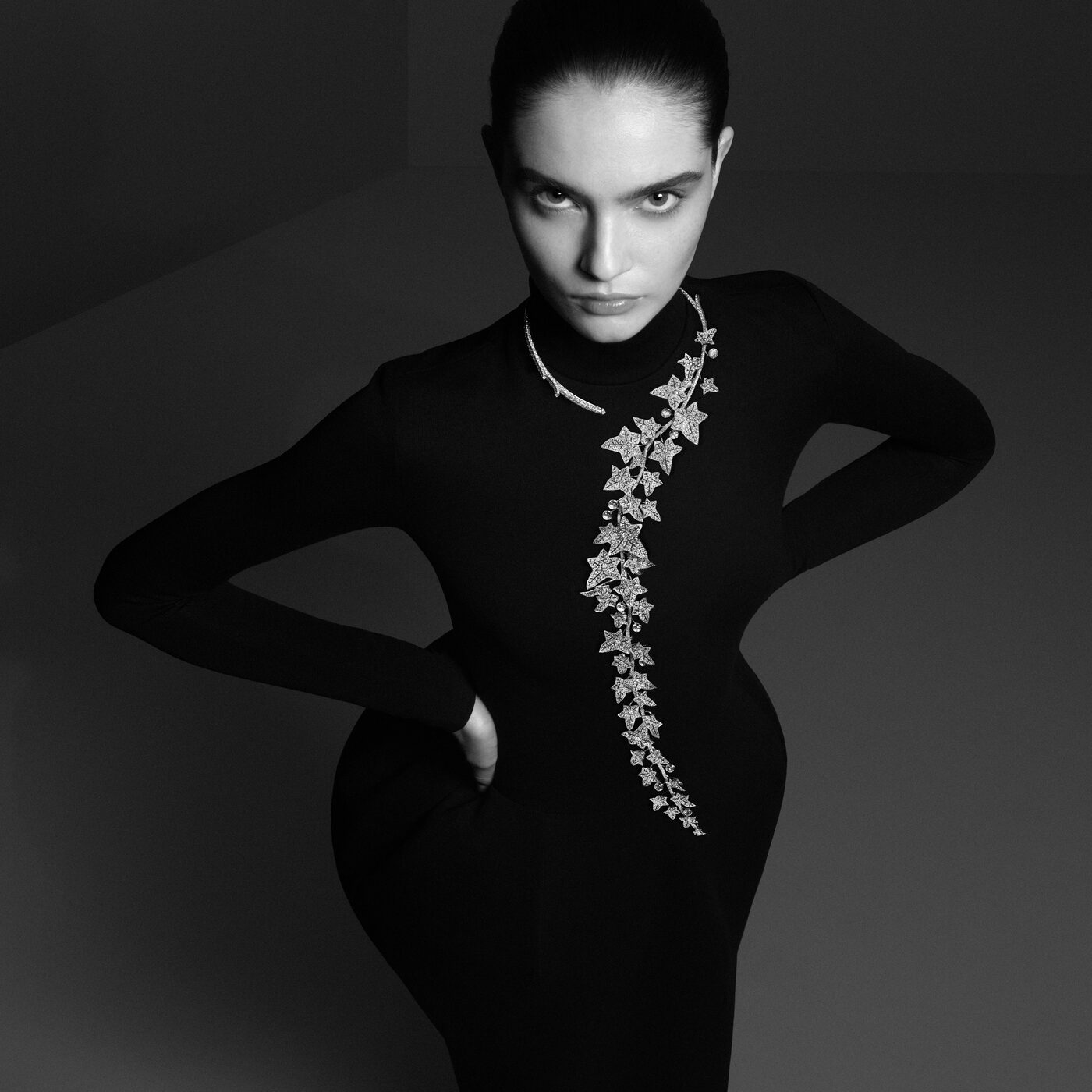 A model wears the Boucheron Lierre de Paris Question Mark necklace, ivy leaves set in diamonds cascading over one shoulder