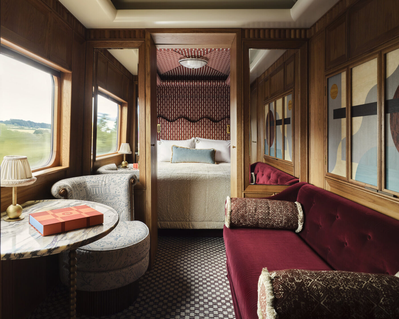 A cabin aboard Britannic Explorer, A Belmond Train, with the English countryside passing the window