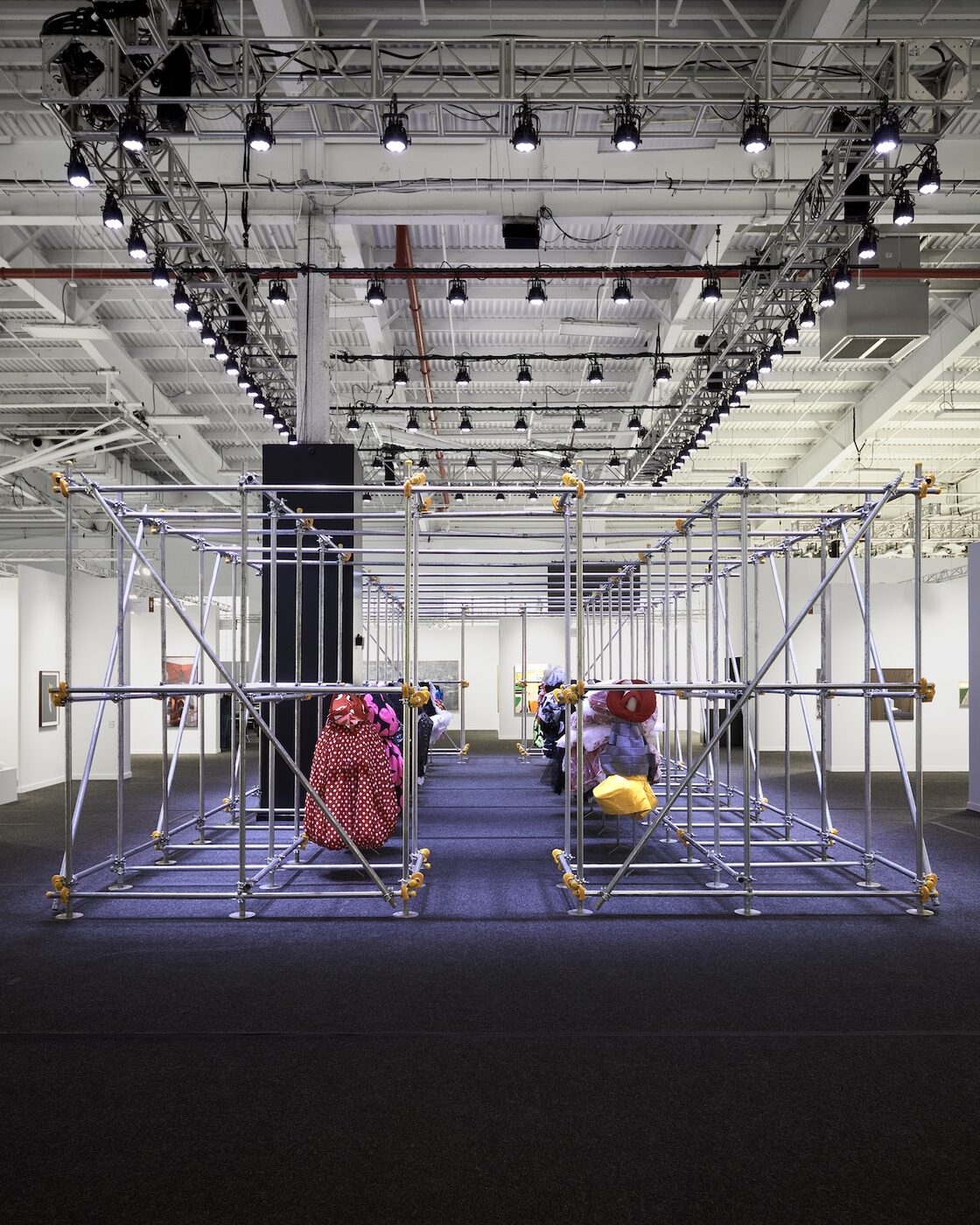 Comme des Garçons garments inside Rei Kawakubo's scaffolding at Independent, Pier 36, New York