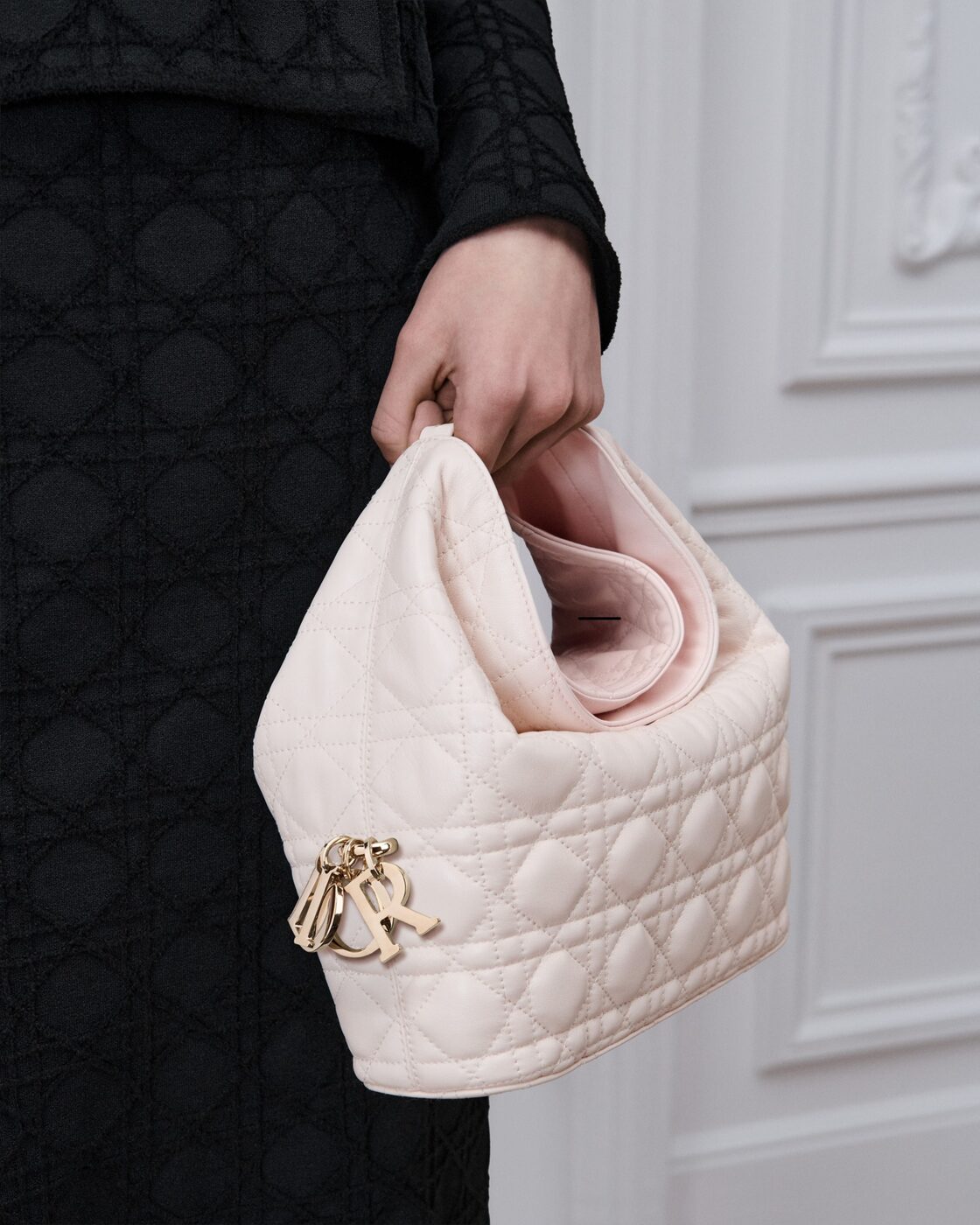 A model carries the Dior Toujours Hobo in ballet pink Cannage lambskin, from Jonathan Anderson's Winter 2027 collection