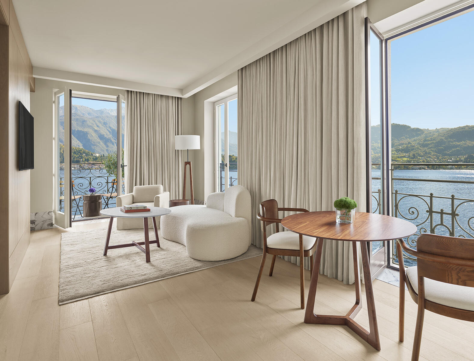 The Lake Como EDITION — Loft Suite with lake views through arched windows, Neri & Hu interiors