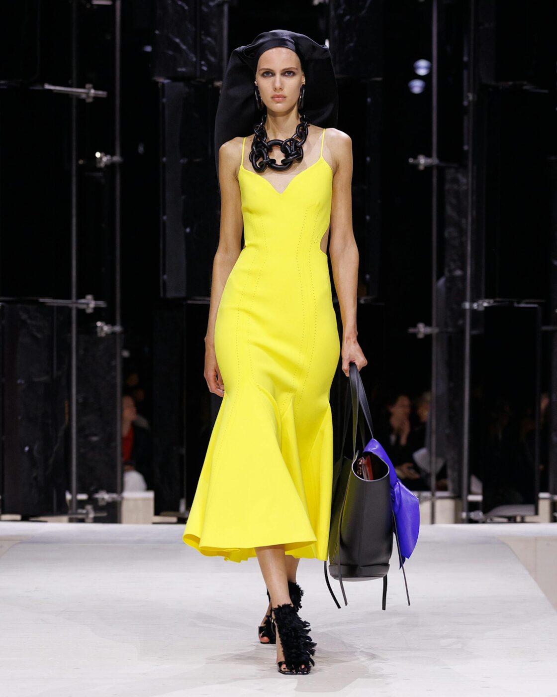A Givenchy Fall-Winter 2026 look by Sarah Burton, tailoring and drape in deep jewel colour
