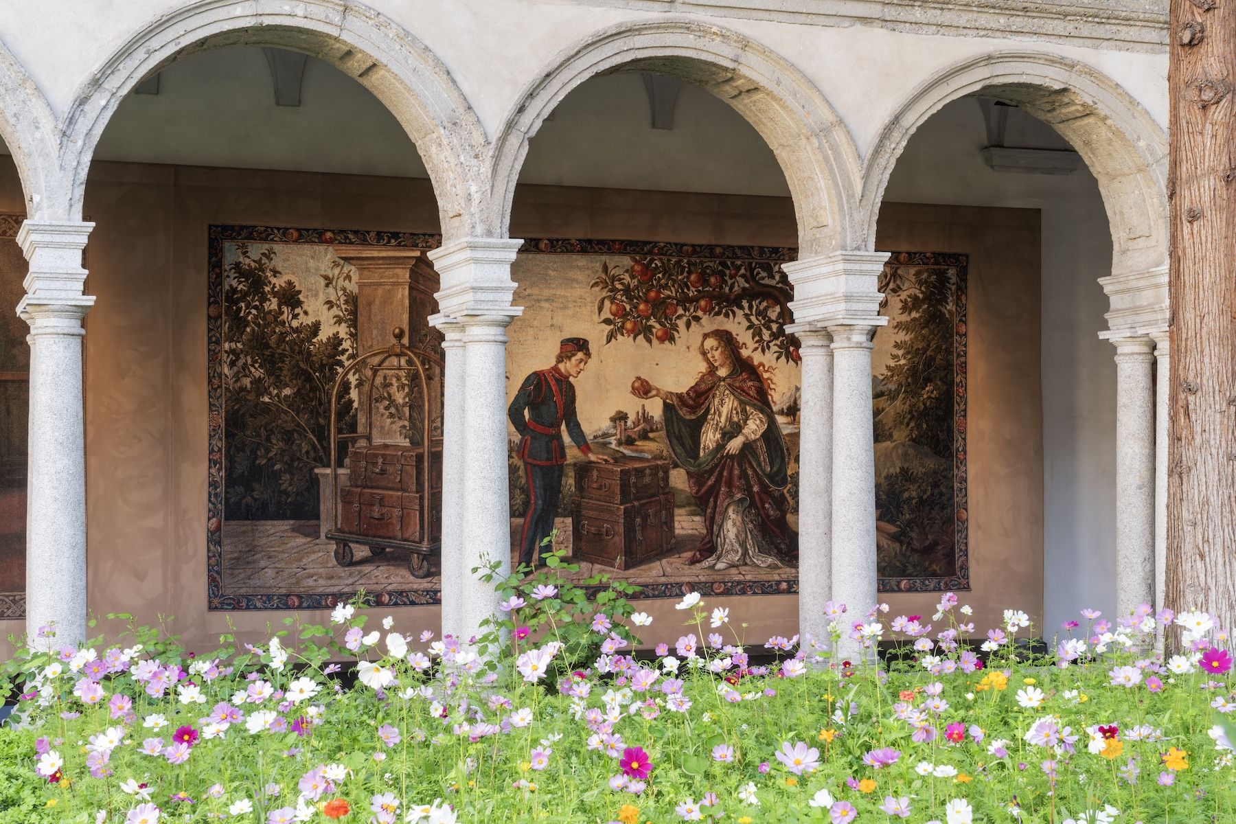 A Renaissance-style tapestry from Gucci Memoria hung at the Chiostri di San Simpliciano in Milan, depicting scenes from the house's hundred-and-five-year history
