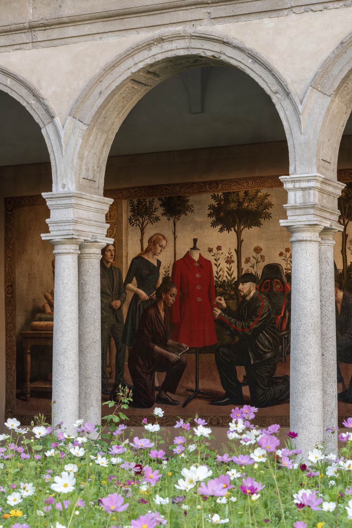 A detail from one of the twelve Gucci Memoria tapestries at the Chiostri di San Simpliciano, showing a Botticelli-inspired scene with Demna himself rendered in a leather biker jacket