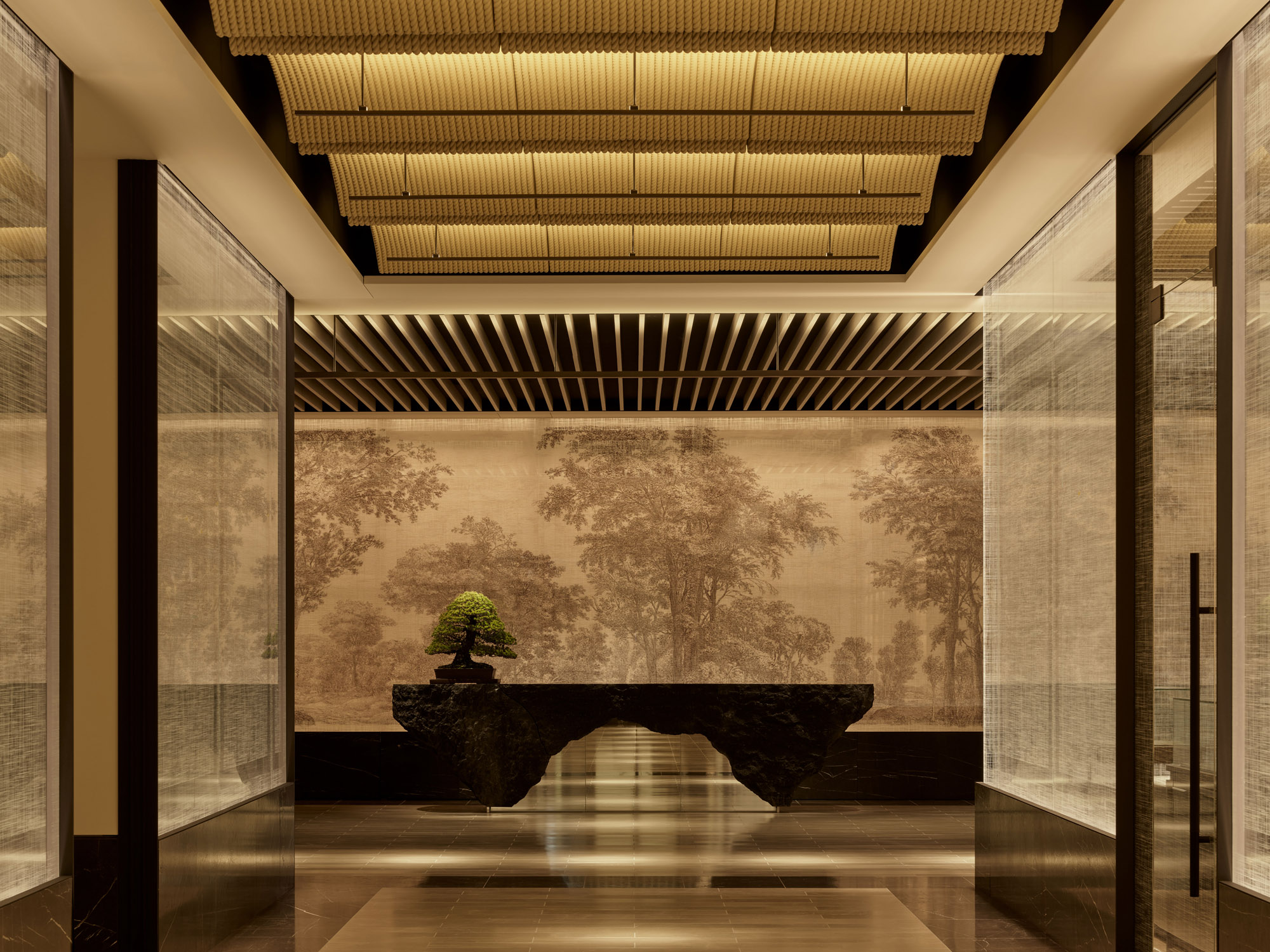 Japanese-style reception with a bonsai tree at Janu Tokyo