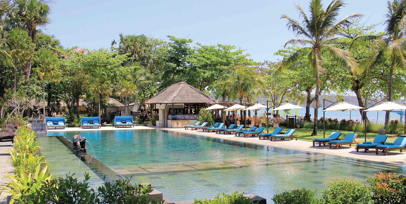 The beachfront pool and thatched bar at Jimbaran Puri, A Belmond Hotel, Bali