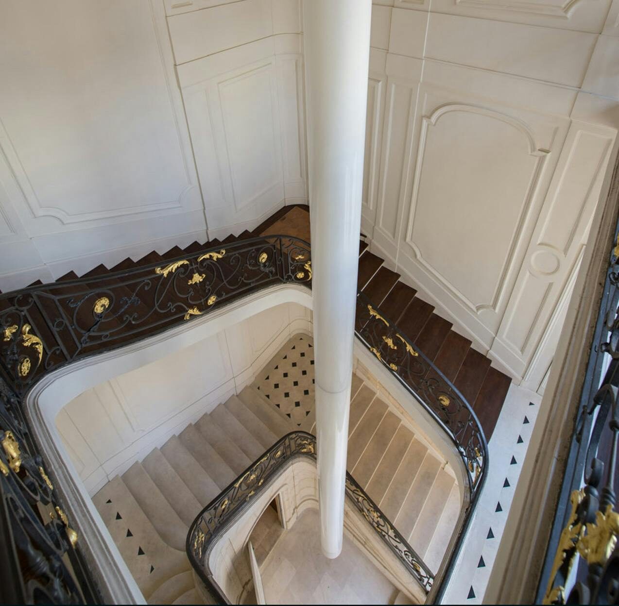 An overhead view of the same staircase inside Kenzo, looking down the stairwell