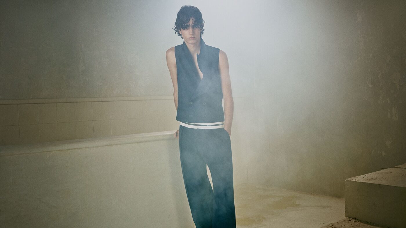 Alexander McQueen Pre-Fall 2026 campaign, a tailored waistcoat and wide trousers in a misted interior