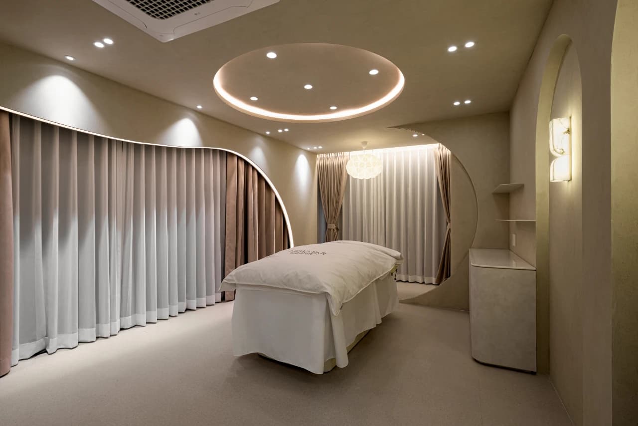 Treatment suite at Newstar Clinic with treatment bed and halo lighting