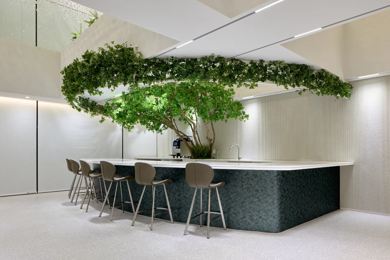Lounge area with indoor tree and bar seating at Newstar Clinic, Seoul