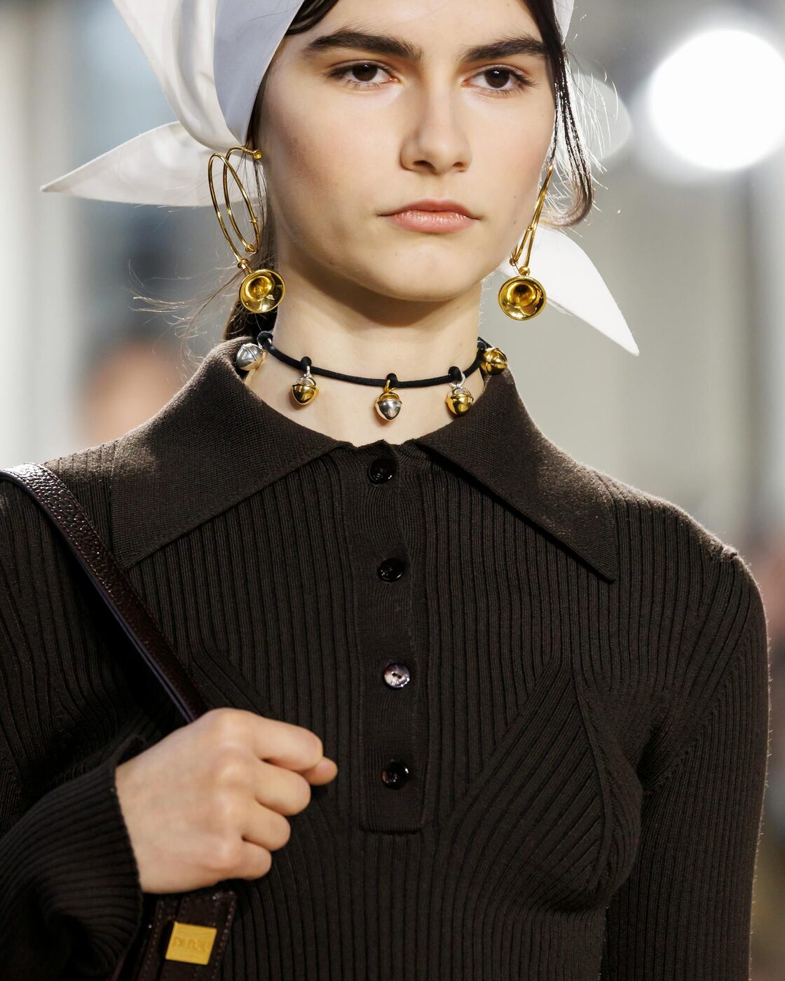 Close detail of a Patou Fall-Winter 2026 look, showing layered texture, luminous colour and fine openwork lace