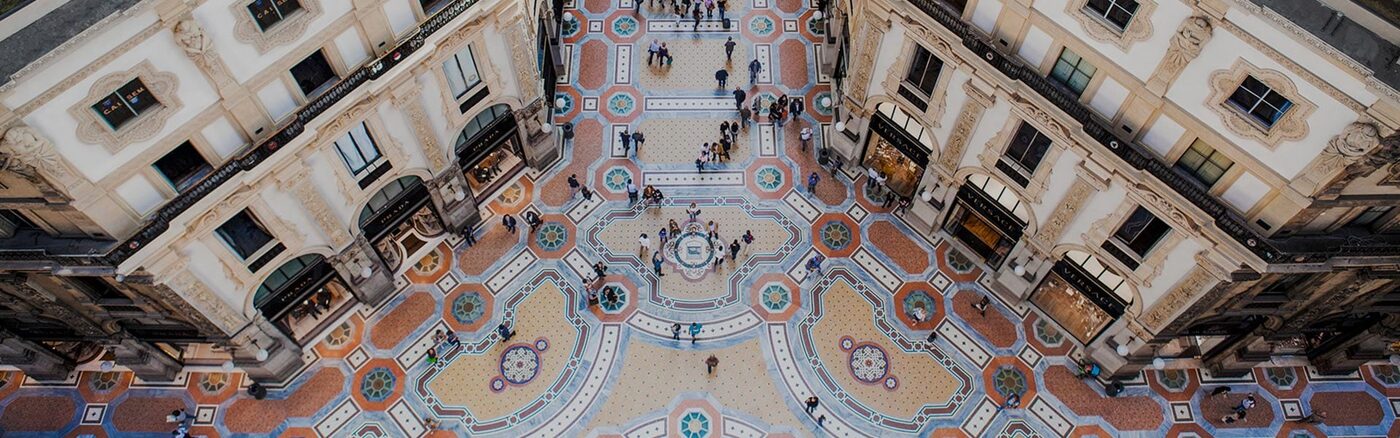 The mosaic floor of the octagon of the Galleria Vittorio Emanuele II seen from above, with the Prada store on the left