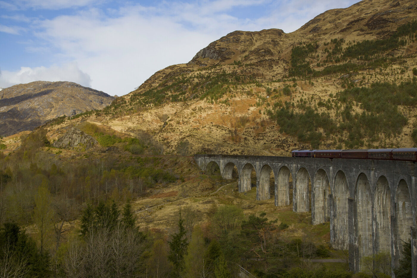 The Royal Scotsman, A Belmond Train, crossing the Glenfinnan Viaduct in the Scottish Highlands, courtesy of Belmond