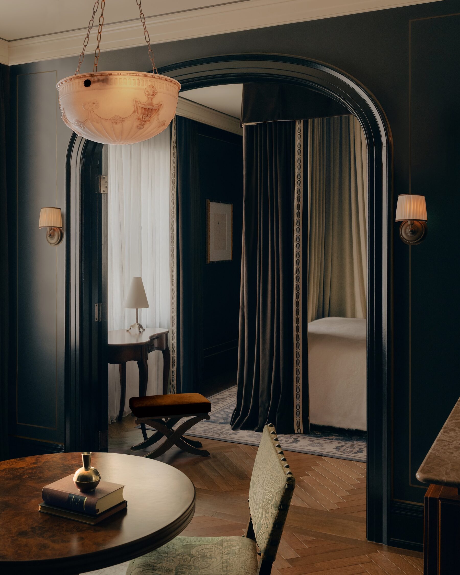A guest room at The Twenty Two New York with herringbone carpet and period furnishings
